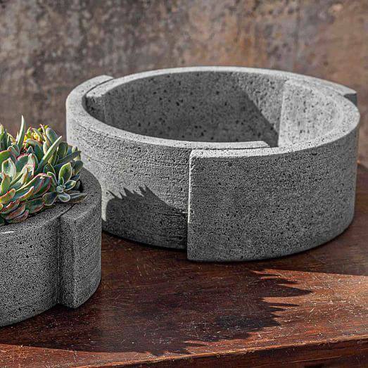Modular rough concrete circular planter on wood surface