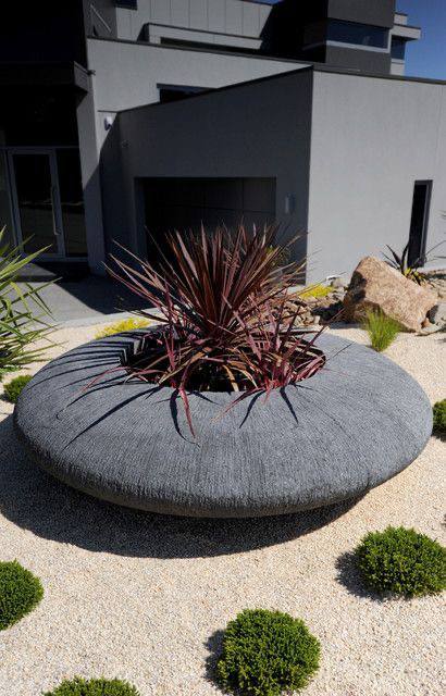 Image 9: architectural circular concrete planter in gravel garden